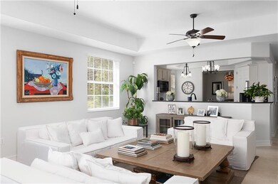 Living Room with Two Fans. Adjacent to Kitchen wit