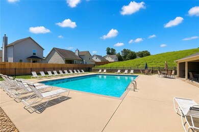 Community pool featuring a patio area and a residential view