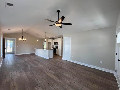 Unfurnished living room with ceiling fan with nota
