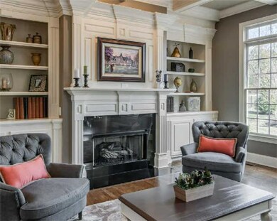Just beautiful!  Well proportioned, built-in bookcases, cabinets, and exquisite mouldings around the fireplace.  