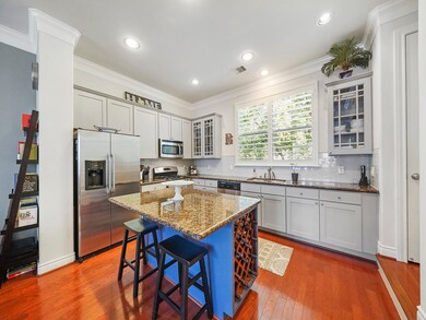 Open kitchen with granite counter tops, stainless appliances, custom cabinetry and a breakfast bar!