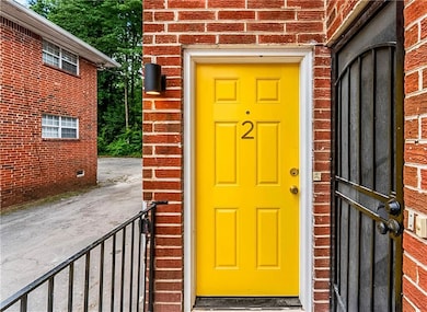 Property entrance featuring brick siding