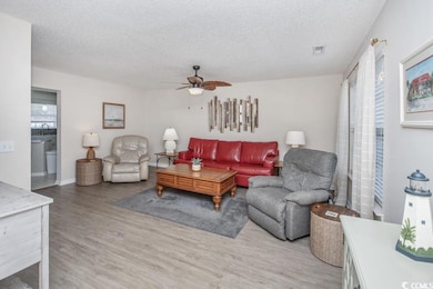 Living area with light wood finished floors, a tex