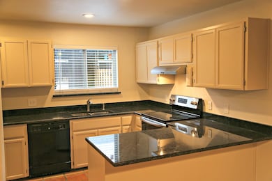 Kitchen with black dishwasher, a sink, stainless 