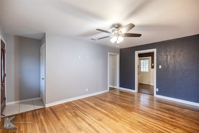 Unfurnished bedroom featuring light wood-style flooring and a ceiling fan