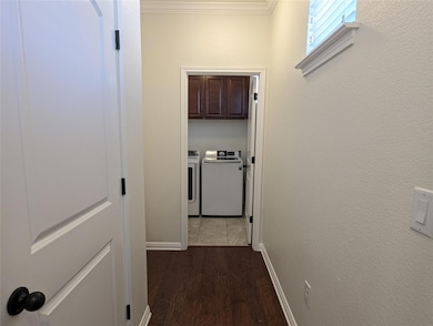 Corridor featuring crown molding, baseboards, was