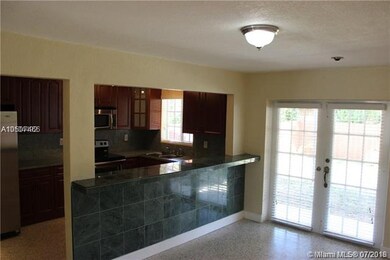 View from dining area into kitchen and rear yard.