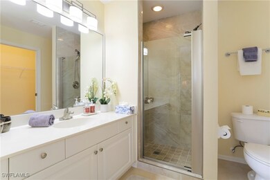 Bathroom featuring vanity, toilet, an enclosed sho