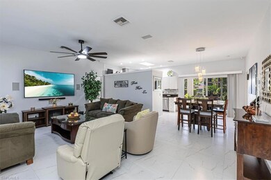 Living room with light marble finish floors and ceiling fan