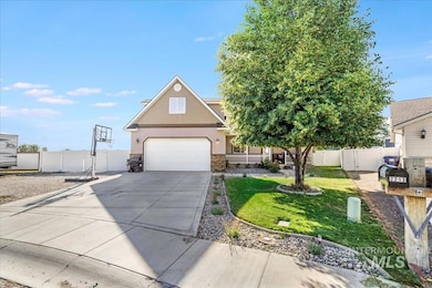 View of front of property with driveway, stone siding, a garage, and stucco siding