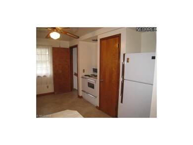 Kitchen includes refrigerator, oven and range.