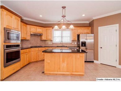 Open and airy kitchen with maple cabinets, new gra