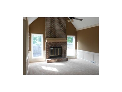 Family room w/ vaulted ceiling, ceiling fan. Wood 