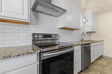 Kitchen with tasteful backsplash, wall chimney ran