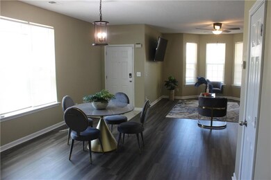 Dining room with dark wood finished floors and ceiling fan