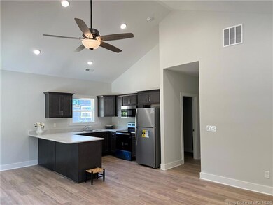 Kitchen with vaulted ceiling.