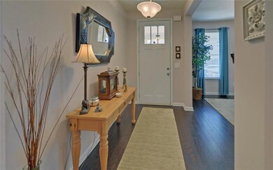 Foyer with plenty of natural light and dark wood finished floors