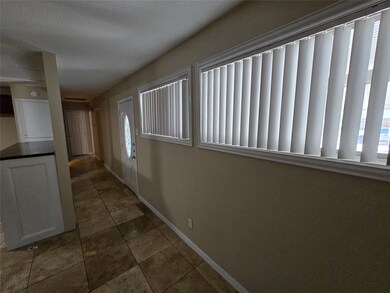 Hall featuring dark tile patterned flooring