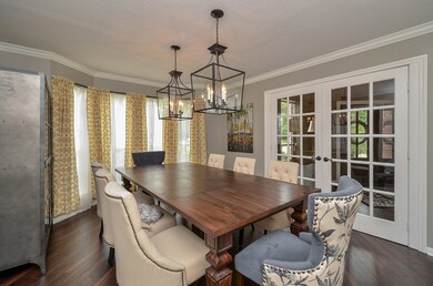 The formal dining room features designer light fixtures and plenty of space to gather your family and friends for holidays, special occasions, and other memorable meals.