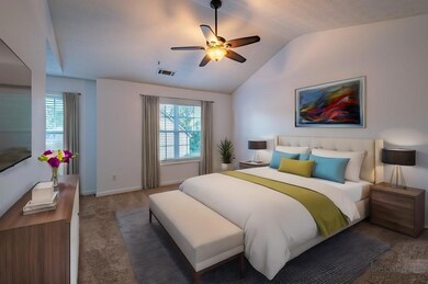 Virtually staged; Bedroom with valuted ceilings with ceiling fan. So large with room for a seating area and king sized bedroom set.