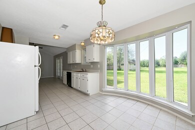 Gorgeous breakfast room and bay windows with a stunning view of the enormous yard and green space