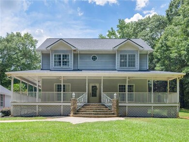 Farmhouse-style home with a porch, a shingled roof, and a front yard