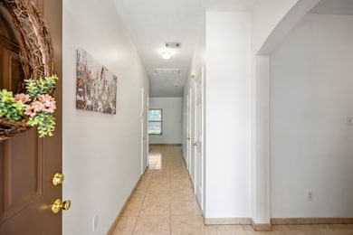 This bright, tile-lined entry welcomes you with cl