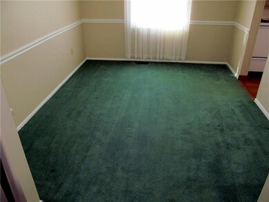 Large dining room with chair rail.