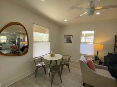 Dining space with baseboards, light wood-type flo
