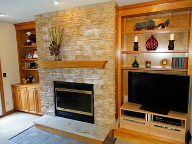 Family Room. A charming stone fireplace is masked 