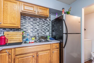 Kitchen with a textured ceiling, stainless steel f