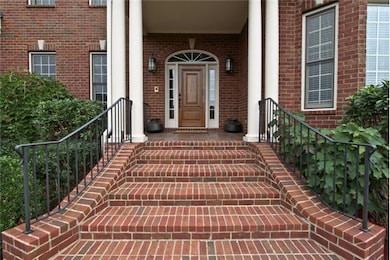 WELCOME HOME...  Dramatic front steps lead to front covered porch with solid wood front door and side lights and transom above.