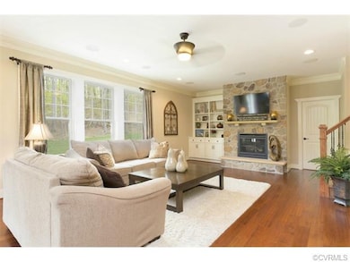 Floor-to-ceiling stone fireplace and custom built-