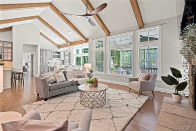 Oversized windows with transoms above fill the liv