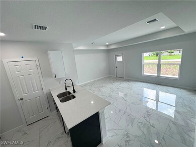 Kitchen featuring light marble finish flooring, wh