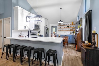 Kitchen featuring white cabinets, a breakfast bar,