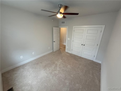 Unfurnished bedroom featuring carpet floors, a clo