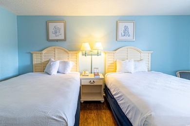 Bedroom featuring a textured ceiling and dark hard