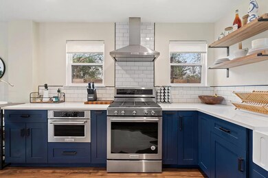 Kitchen featuring range hood, stainless steel app