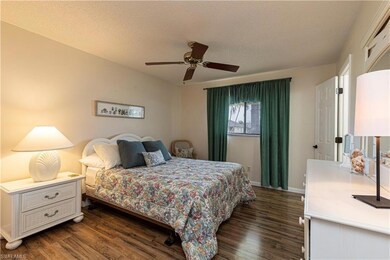 Bedroom with a textured ceiling, ceiling fan, and 