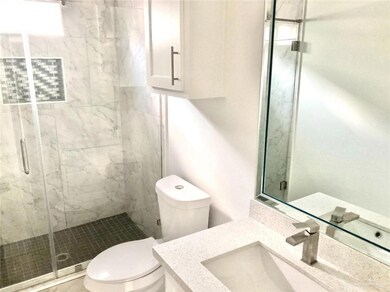 Full bathroom with vanity and a shower stall