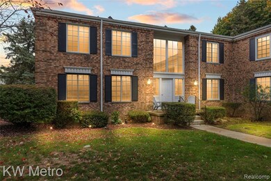 Colonial inspired home with a front yard and brick siding