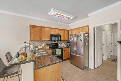 Kitchen featuring black appliances, a peninsula, c