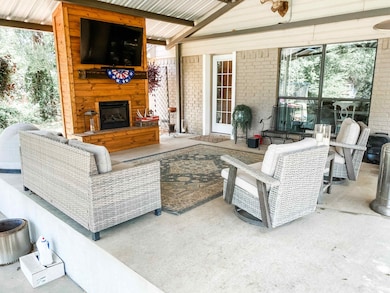 View of new patio / terrace with a large fireplace