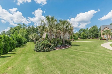 View of grassy yard with view of wooded area