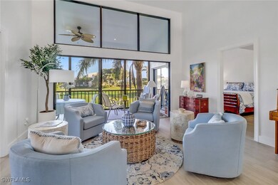 Living room with a towering ceiling, ceiling fan,