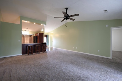 Unfurnished living room with carpet floors, lofted