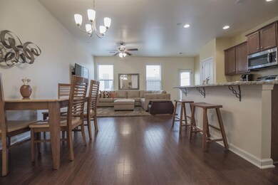Walking into the open living, kitchen and dining room