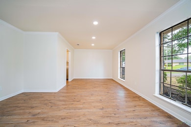 Spare room featuring crown molding, light wood-style floors, and recessed lighting
