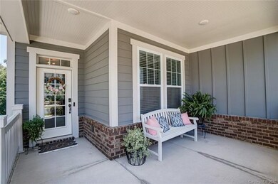 Covered front porch welcomes to beautiful light fi